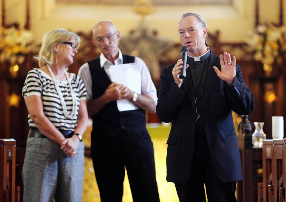 Father Peter McLeod-Miller addresses last night’s forum at St Matthew’s Church with Susie Reid and Pieter Mourik. More than 100 people attended. Picture: JOHN RUSSELL