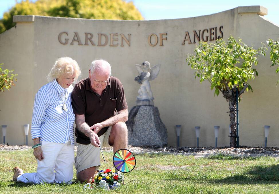 Maureen and Tim Byrnes, from Albury, at their grandson Joshua’s grave. They welcomed works to improve Glenmorus’ Garden of Angels. Picture: KYLIE ESLER