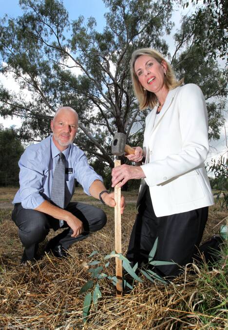 Wodonga councillor Michael Fraser and Victorian parliamentary health secretary Georgie Crozier plant a tree to mark the launch of the workplaces in open spaces initiative for the city yesterday. Picture: DAVID THORPE