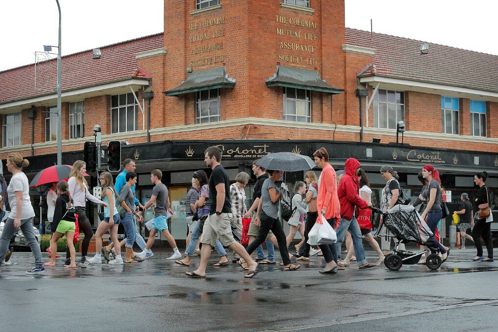 Shoppers splash out in Dean Street, not letting a little rain spoil their last-minute Christmas shopping. Picture: TARA GOONAN
