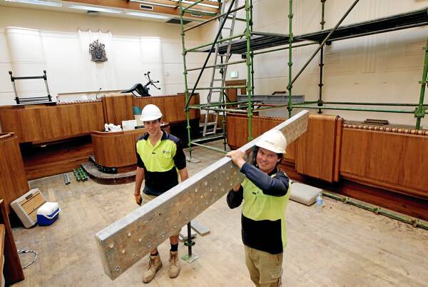 Builders Jordan Hallam and James Batchelor, of Moretto Building, set up scaffolding in court one yesterday in readiness for the painting of the main court room. Picture: PETER MERKESTEYN