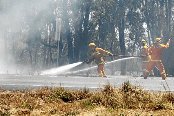 Wodonga firefighters extinguish their first median strip blaze on the Hume Freeway, near Melbourne Road. It was believed to be lit by a cigarette butt or mechanical failure. Picture: PETER MERKESTEYN