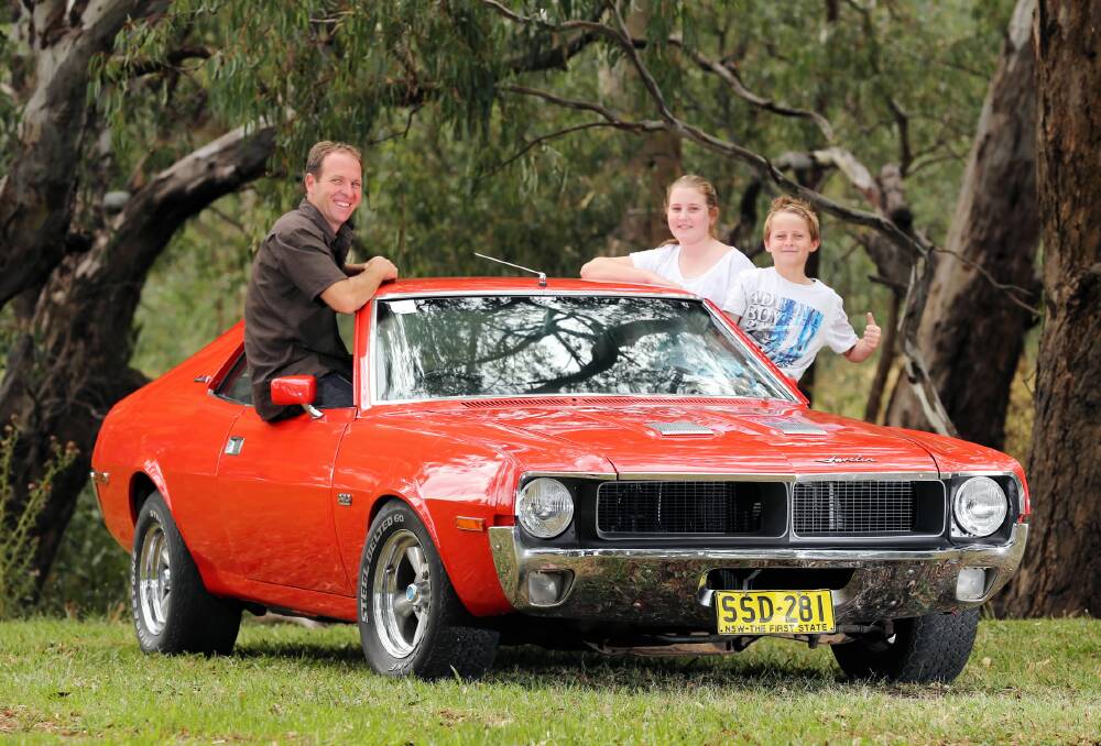 One day, Harry, it will be all yours. Matt Lukins with his children Harry and Georgia and his 1970 Javelin. Picture: JOHN RUSSELL