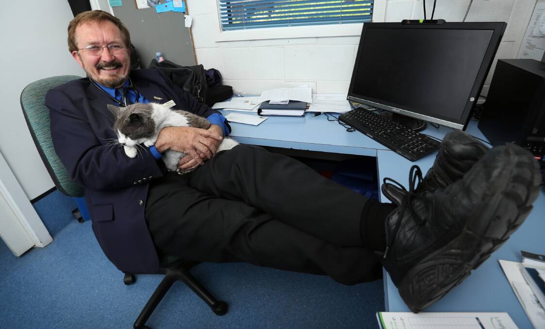 Arthur Frauenfelder relaxes in North Albury with one of the smaller cats. Picture: MATTHEW SMITHWICK