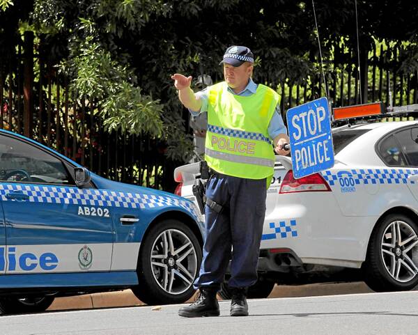 Sgt Daniel Mills calls in a driver for a random breath test in Young Street in Albury yesterday. Police on both side of the border are starting their Christmas campaigns. Picture: DAVID THORPE