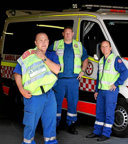 Paramedics Scott Glover, Ash Willis and David Cunningham are wearing yellow vests to highlight their unhappiness. Picture: MATTHEW SMITHWICK