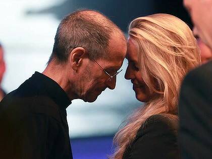 Steve Jobs leans his forehead against his wife, Laurene Powell Jobs, after delivering the keynote address to the Apple Worldwide Developers Conference in June.