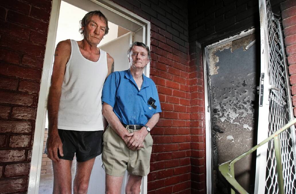 Rodney Flinleyson and Kerry Whitlock inspect damage caused by a unit fire on Thursday. Picture: BEN EYLES