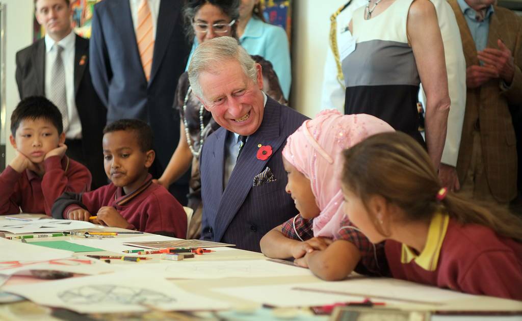 Prince Charles, Prince of Wales talks to children during a visit to the Australian Tapestry Workshop in Melbourne, Australia.
