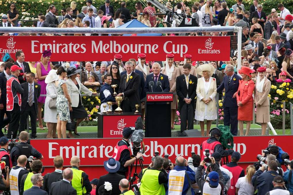 Prince Charles and Duchess of York Camilla Parker-Bowles at the Melbourne Cup presentation. Photograph of the winning jockey Brett Prebble accepting his cup.