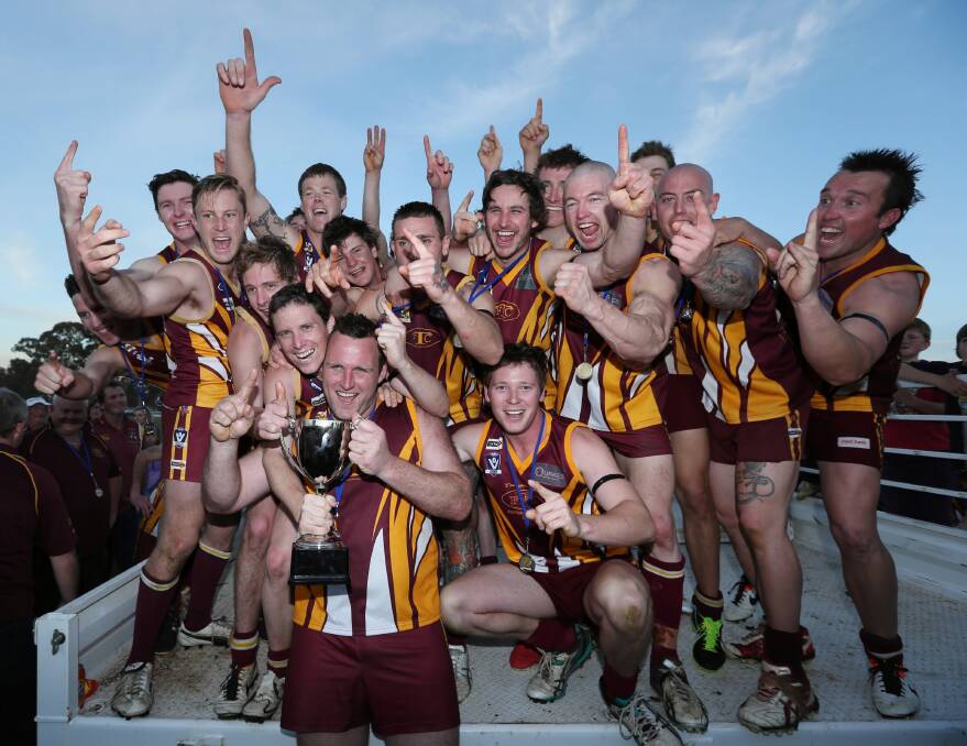 Tungamah premiership players celebrate after their win with the premiership cup. Pictures: MATTHEW SMITHWICK