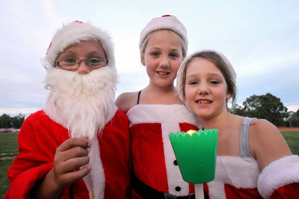 Connor Flavell, 9, Taylor Donelan, 10, and Elley Donelan, 7, get into the Christmas spirit.