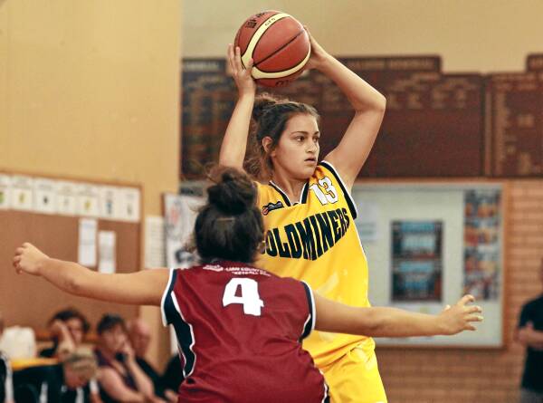 Goldminers’ Eliza West looks to pass in front of Bushrangers’ Shelby Britten.
