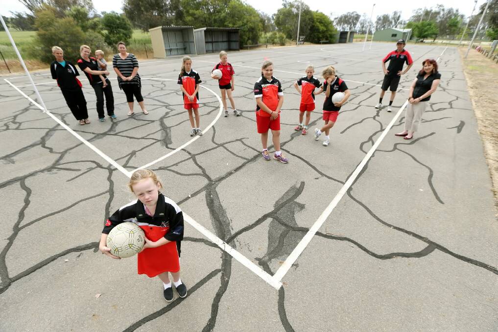 Paige McKimmie, 6, is delighted as teammates, coaches, parents and community members to hear the Burrumbuttock netball courts can be upgraded with the help of a state grant. Picture: JOHN RUSSELL