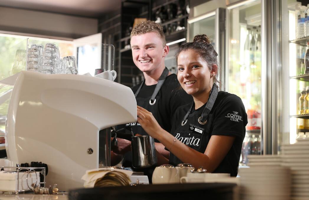 Michael Brownsea and Evie Sloan are heeding WorkCover’s safety rules in their work at the Coffee Club Albury. Picture: JOHN RUSSELL
