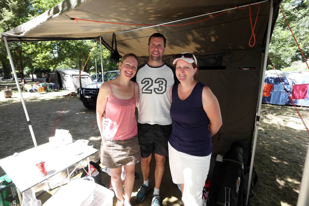 Katie and Matt Wood, of Sydney, with friend Karen Smith, from Orange, relax in the shade at the popular Colac Colac Caravan Park near Corryong. Picture: PETER MERKESTEYN
