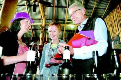 l Brown Brothers representative Kate Looney helps Gary and Sue Scholz from Mount Bruno with their wine selections at the King Valley Wine Shed Show on Saturday. Picture: RAY HUNT