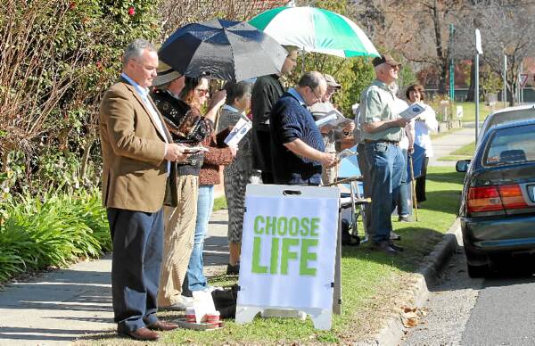 Roland von Marburg yesterday joins the anti-abortion group praying on the opposite side of Englehardt Street to the abortion clinic.