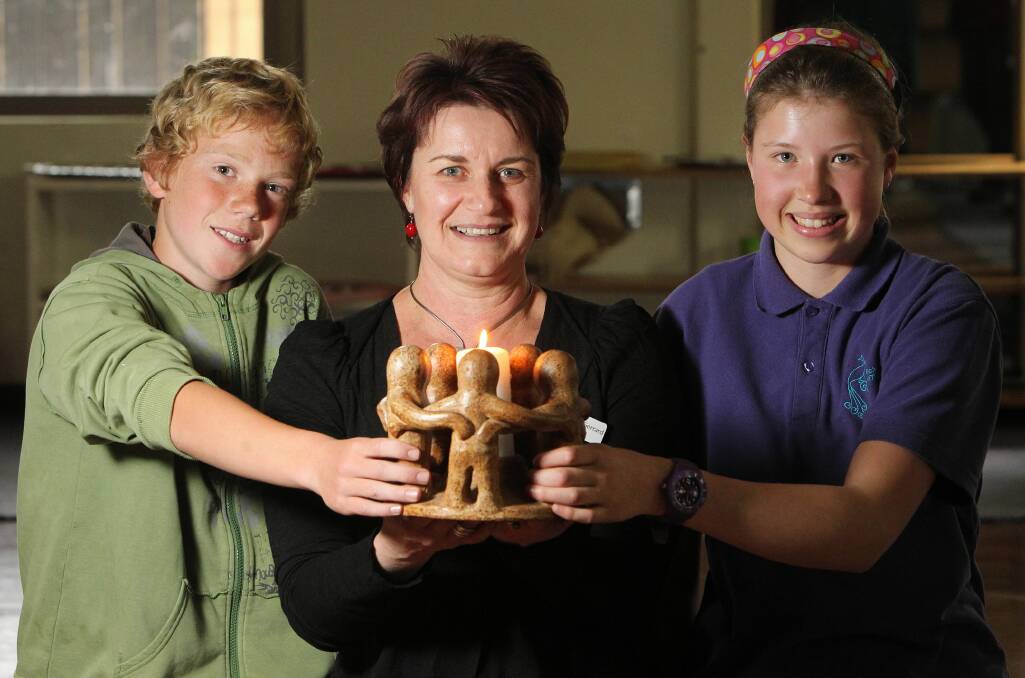 Beechworth Montessori students Finn Jakobsson, 12, and Sophal Hopp, 12, with principal Heather Gerrard, mark the closure of the school yesterday but are excited to move to a new location when the new term begins. Picture: MARK JESSER