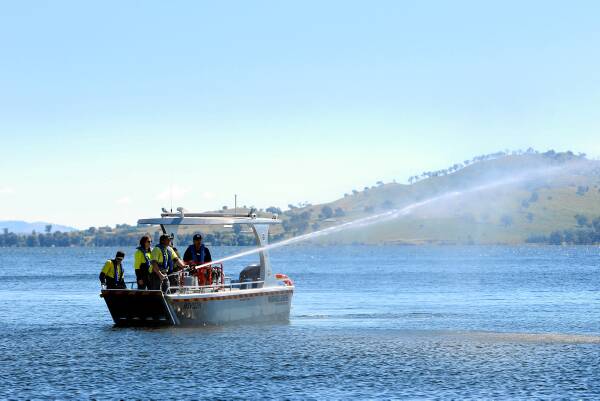 A DSE crew operates a water cannon aboard the new fire-fighting boat. Picture: MATTHEW SMITHWICK