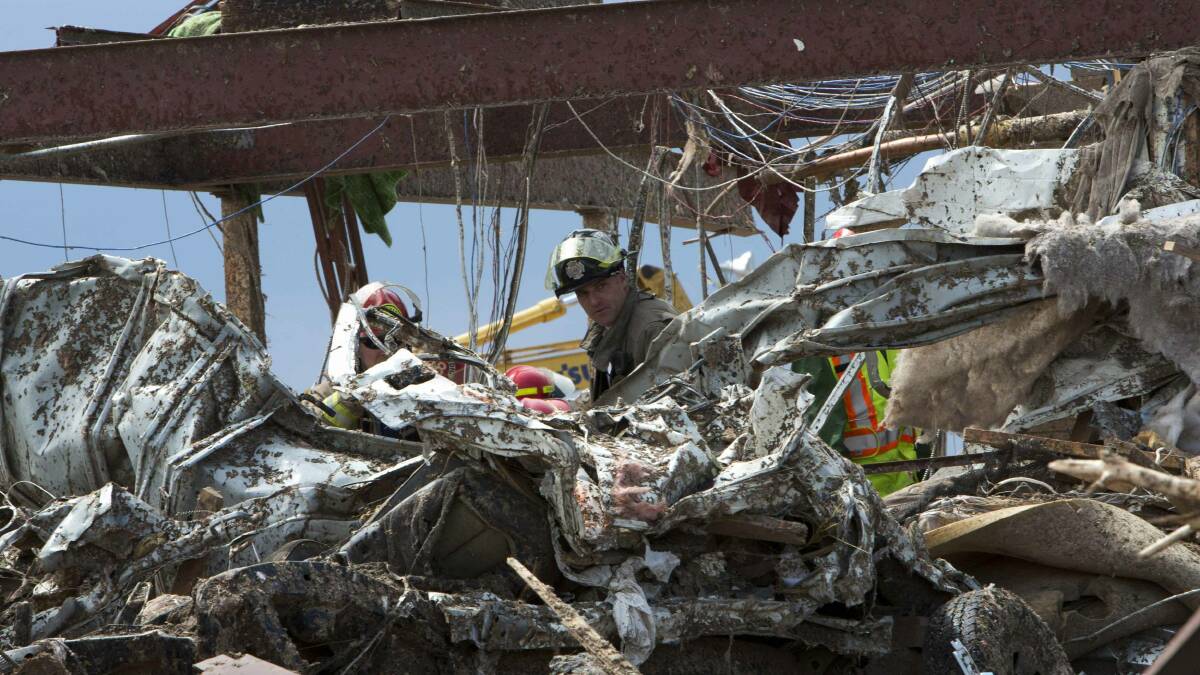 Rescuers search the twisted rubble of the Plaza Towers Elementary school in Moore, Oklahoma. Photo: REUTERS