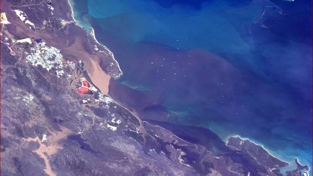 Floodwaters flow into the sea near Gladstone in this photo taken from the International Space Station. Photo: Commander Chris Hadfield