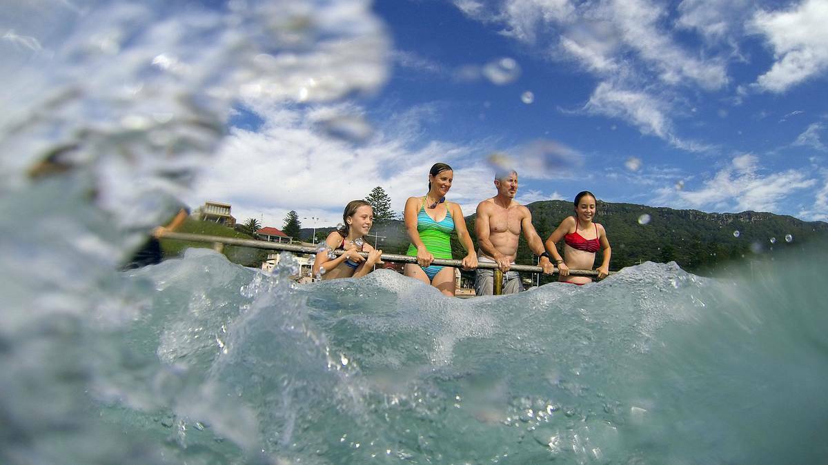 Alyssa, Lisette, Simon and Amelie Abbott enjoy the king tide on the Illawarra coast. Picture: Kirk Gilmour