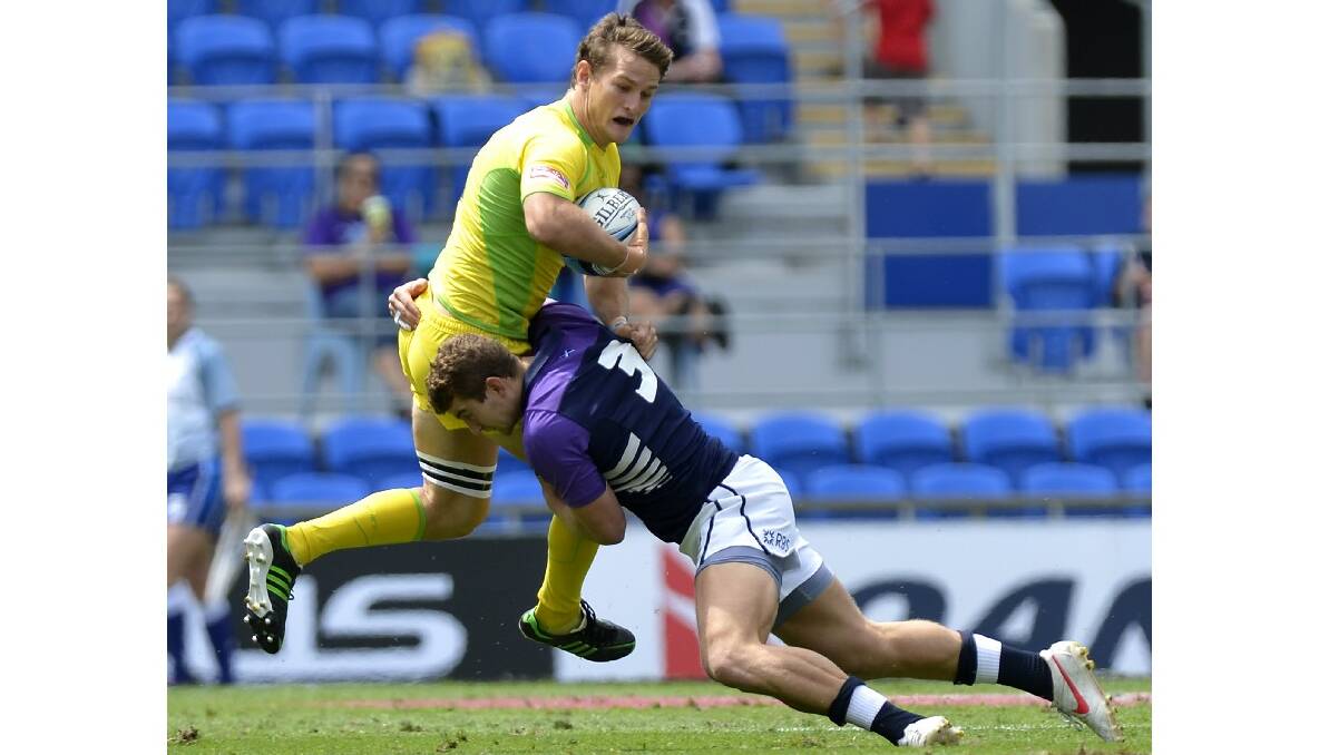 Con Foley of Australia is tackled by Struan Dewar of Scotland during the Gold Coast Sevens round one match between Australia and Scotland. Photo: Getty Images.
