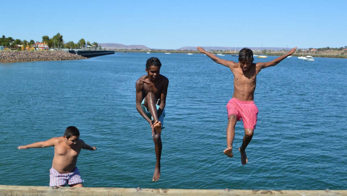 Isaac Haines, Brodrick Newchurch and Sean Reid try some jetty jumping to stay cool in Port Augusta, South Australia.