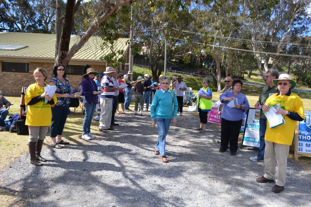 RUNNING THE GAUNTLET: Voters had to run the gauntlet of those handing out for the candidates at the Narooma Sport and Leisure Centre on Saturday.