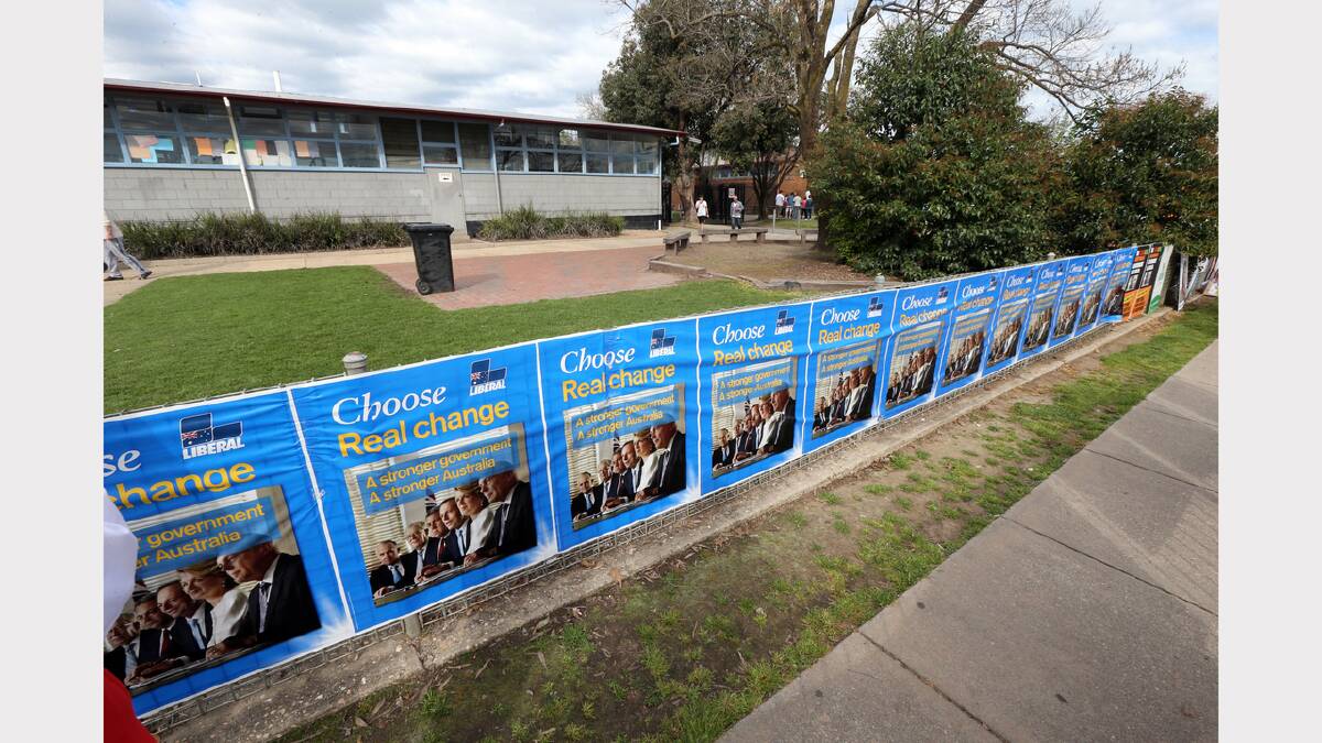 Liberal supporters wallpapered the fences outside Wodonga Senior Secondary College., amid allegations they were put up well before they were supposed to be put up.