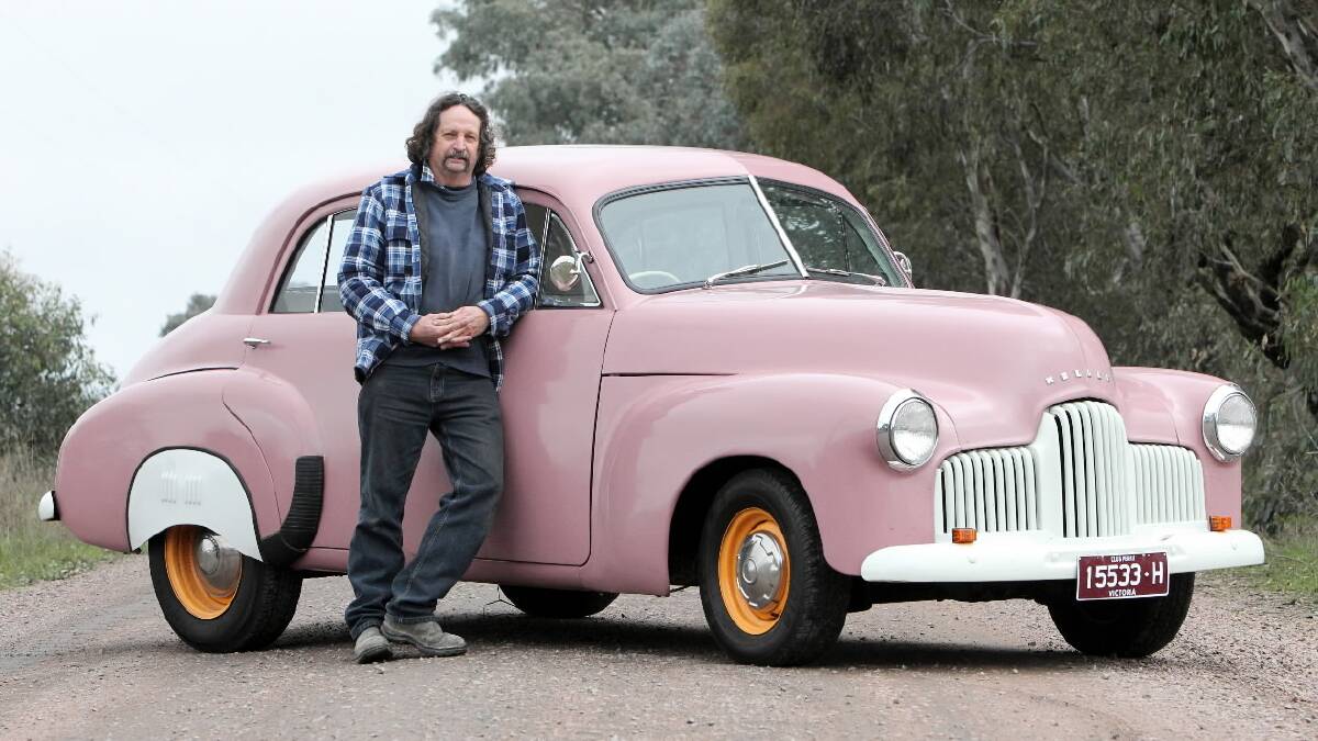 Lawrence Jensen didn’t expect the honour of leading the cars onto the Holbrook bypass yesterday but his pink 1951 FX Holden did the town proud after the concrete barriers were removed. Pictures: MARK JESSER