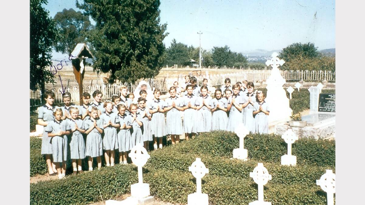 St John's Orphanage girls attend a service at the nun's cemetery at Thurgoona about 1960.