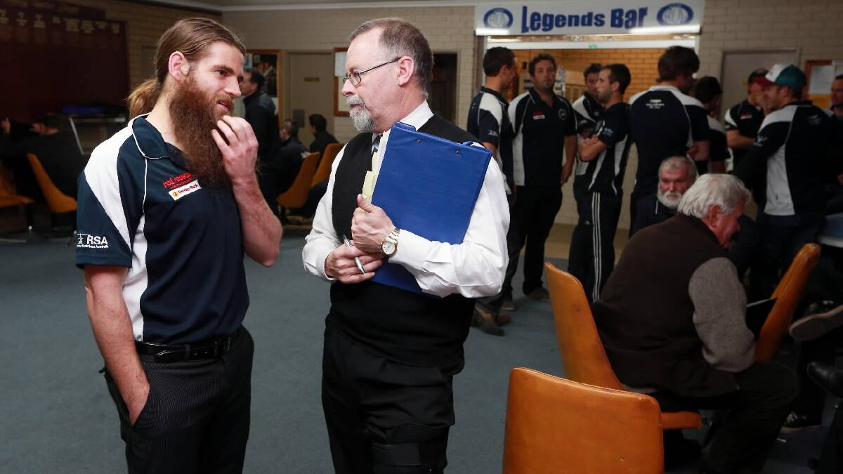 LONG NIGHT: Mitta Football Club’s Justin Nelson, and his advocate, wait with clubmates, and members of the Thurgoona club, for last night’s tribunal hearing in Albury. Picture: JOHN RUSSELL