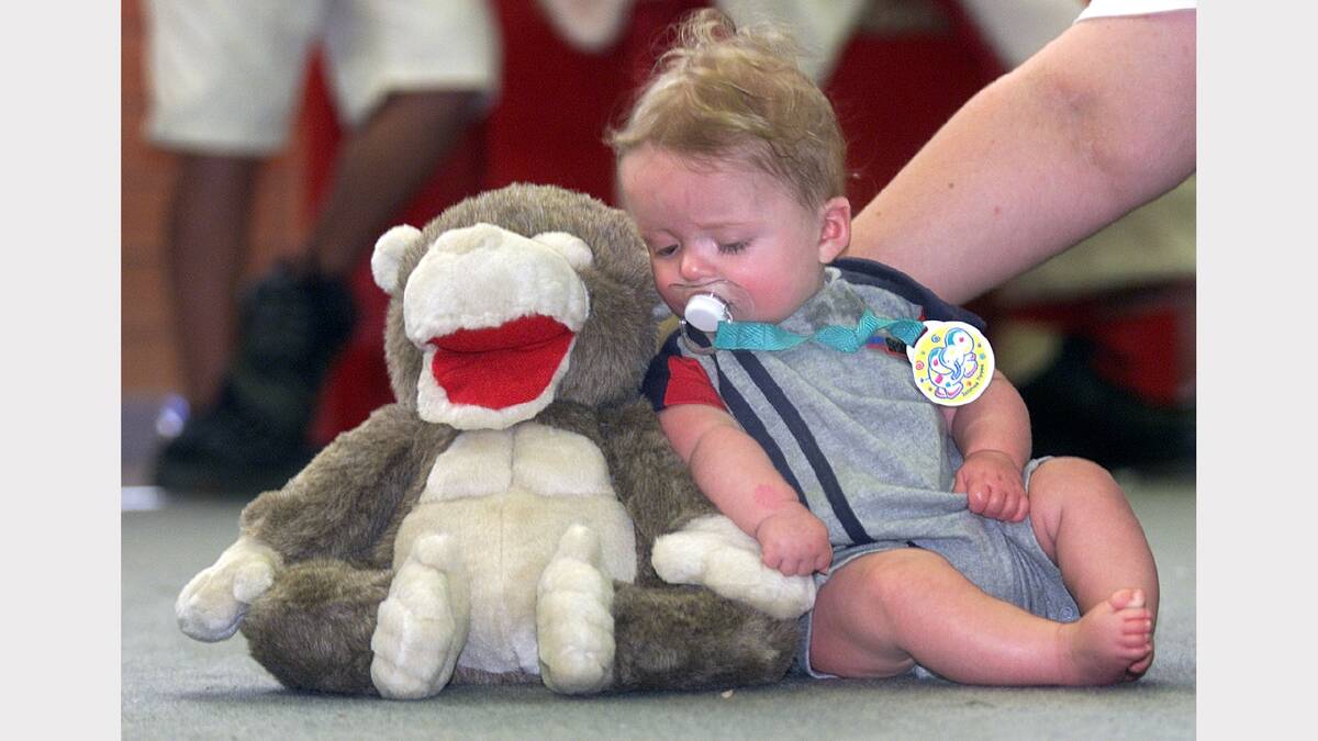 Special Childrens' Christmas Party at the Wodonga Sports and Leisure Centre. Hayden Jamnikar, 5 months, of Albury being presented to Santa, but he was just too tired and wanted to take a nap on the toy Santa just gave him. Picture: PETER MERKESTEYN
