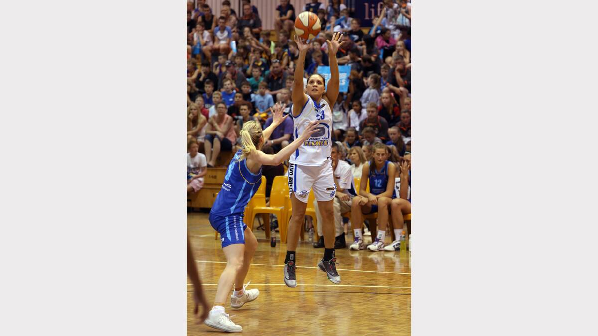 Sydney's Rohanee Cox shoots over Canberra's Carly Wilson.