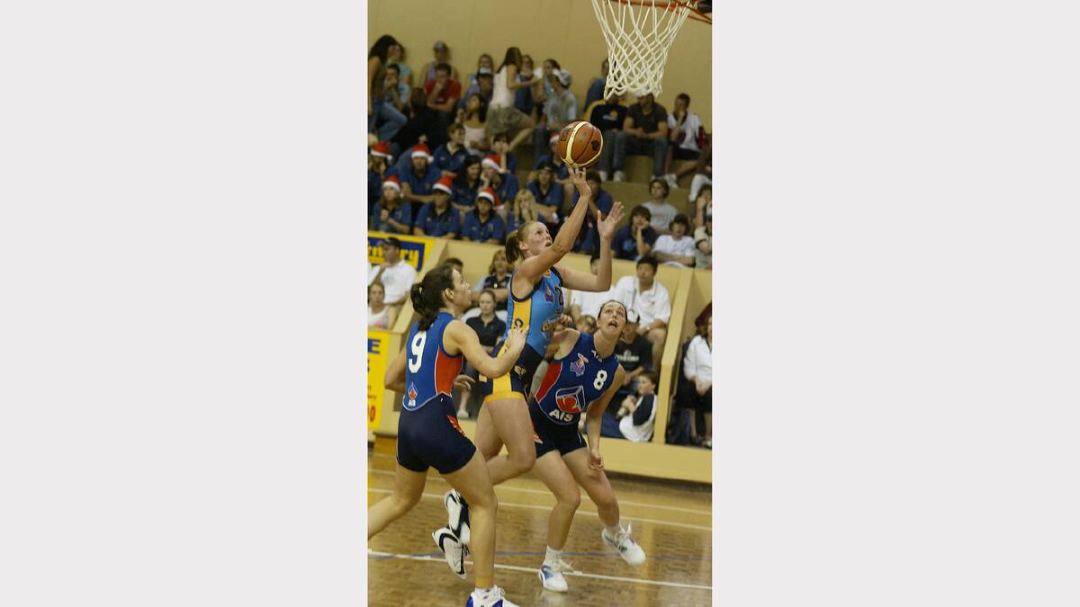 Canberra Capitals' Donna Loffhagen shoots over AIS players #9 Rebecca Duke & #8 Jenna O'Hea during the WNBL clash at the Albury Sports Stadium. Picture: PETER MERKESTEYN