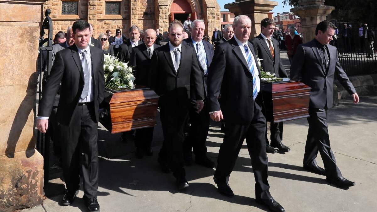 Bill and Pauline Thomas’ son-in-law Brett Cameron carries the coffin on the left with the couple’s son John Thomas at their joint funeral in Wangaratta yesterday. Picture: PETER MERKESTEYN