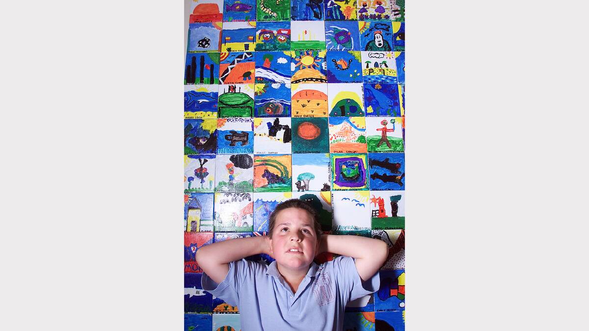 Wodonga Primary School's Trent Schultz with some of the Federation Tiles painted by students at the school. Picture: SIMON DALLINGER