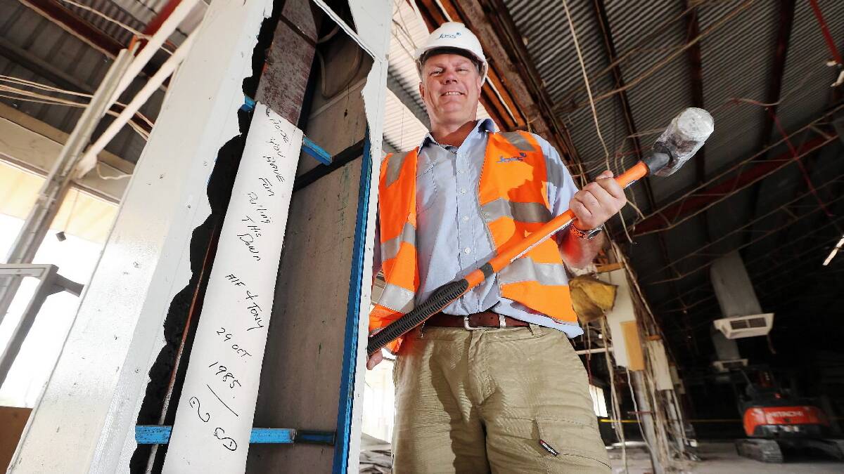 Clint Burgmann with some graffiti left by builders in 1985 and uncovered during the demolition of the old Mann building in South Street, Wodonga, this week. Picture: JOHN RUSSELL