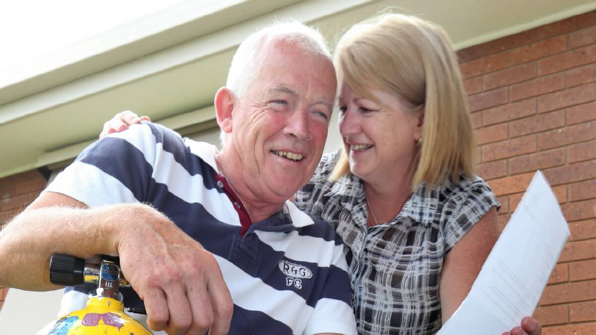Peter Wright is congratulated by his wife Raelene after she opened a letter which named him Corowa’s Citizen of the Year. Picture: PETER MERKESTEYN
