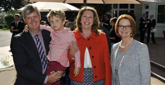 Catherine King is all smiles yesterday as she stands with Prime Minister Julia Gillard, her husband Mark Karlovic and son Ryan Karlovic after being promoted to the frontbench in a reshuffle. 