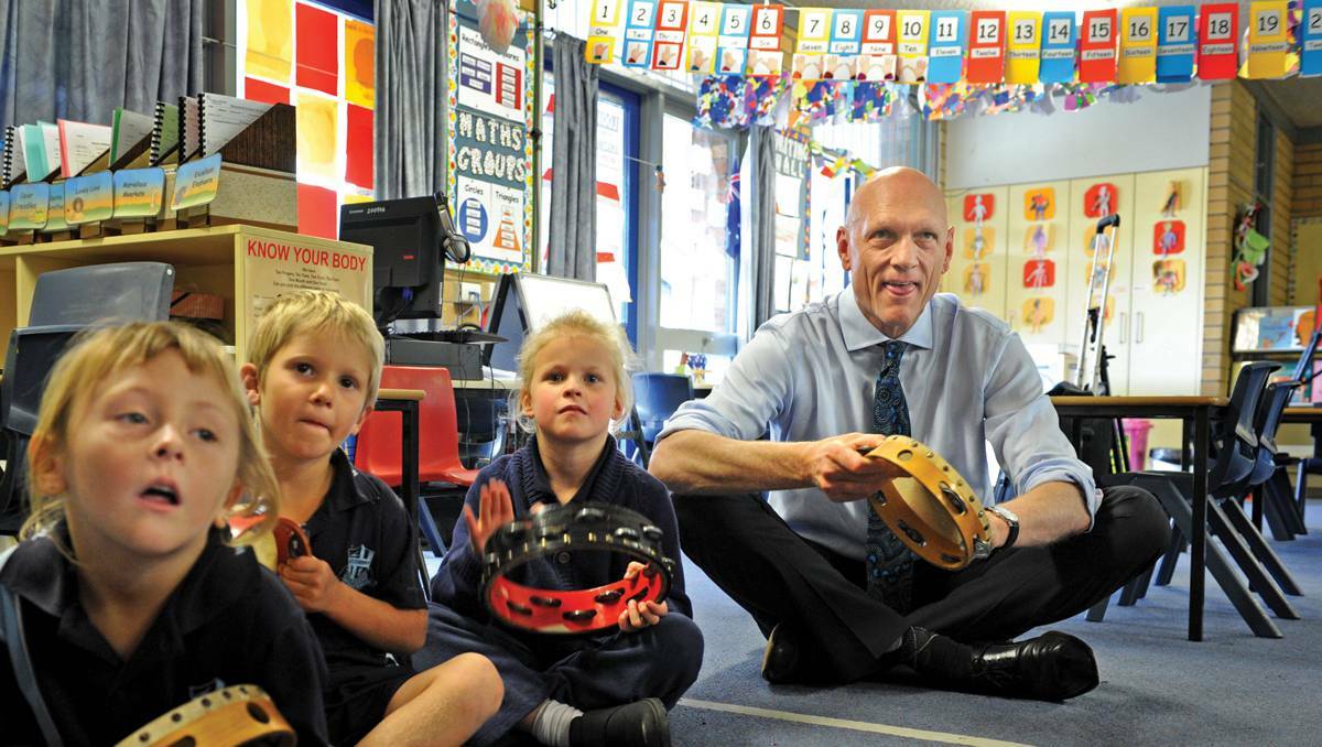 Federal School Education Minister Peter Garrett sits in on a kindergarten music class with Selina, Jacobi and Makayla