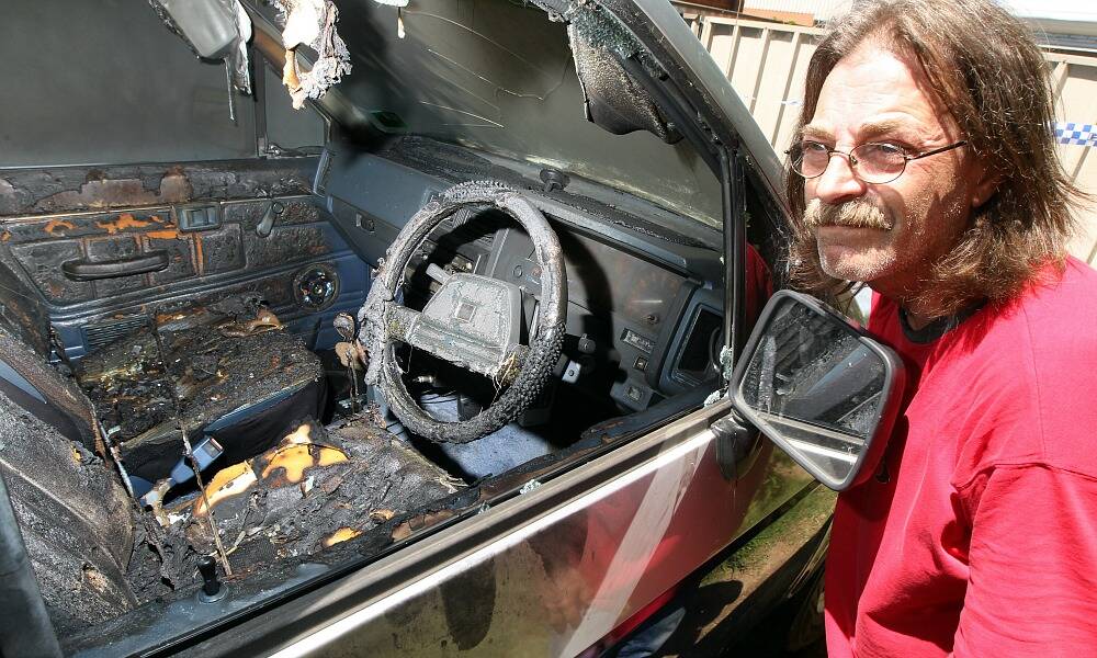 Peter Tanner with his burnt-out Nissan Navara. Picture: PETER MERKESTEYN