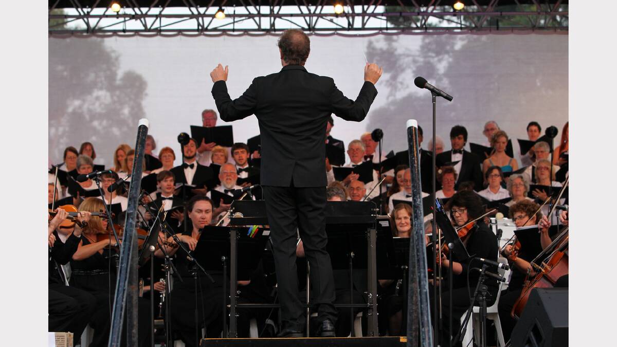 Conductor Guy Noble leads the orchestra.