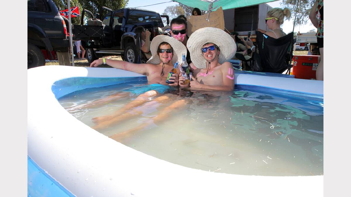 Kerrod Spokes, of Darwin, Brett Wilson, of Holbrook, and Nick Pugh, of Wollongong, cool down in their inflatable pool at the Holbrook B&S. PICTURE: Tara Goonan.