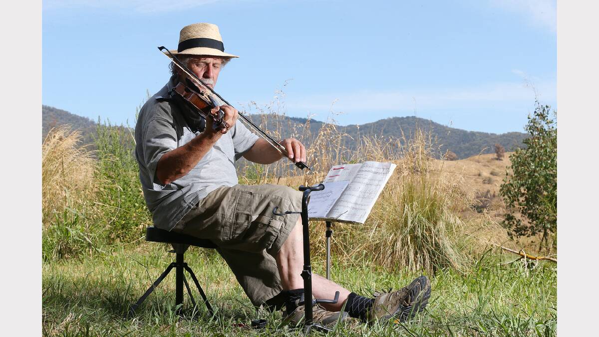 Arthur Rich gets a tune going in the shadow of the distant hills. PICTURE: John Russell.