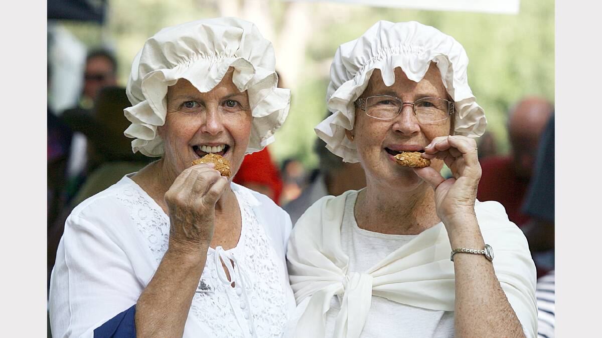 Noreuil Park, Australia Day Ceremony 2013, Gaye Merkel, of Albury, and Anne Simmonds, of Albury, munching on some ANZAC biscuits while dressed up in colonial clothes to promote their group 'The Fellowship of First Fleeters'. PICTURE: Tara Goonan.