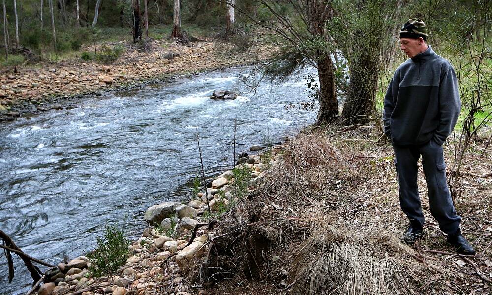 Drayton Douglas beside the river near where he and missing man Devin Carracher, inset, began their fishing trip. Picture: KYLIE ESLER