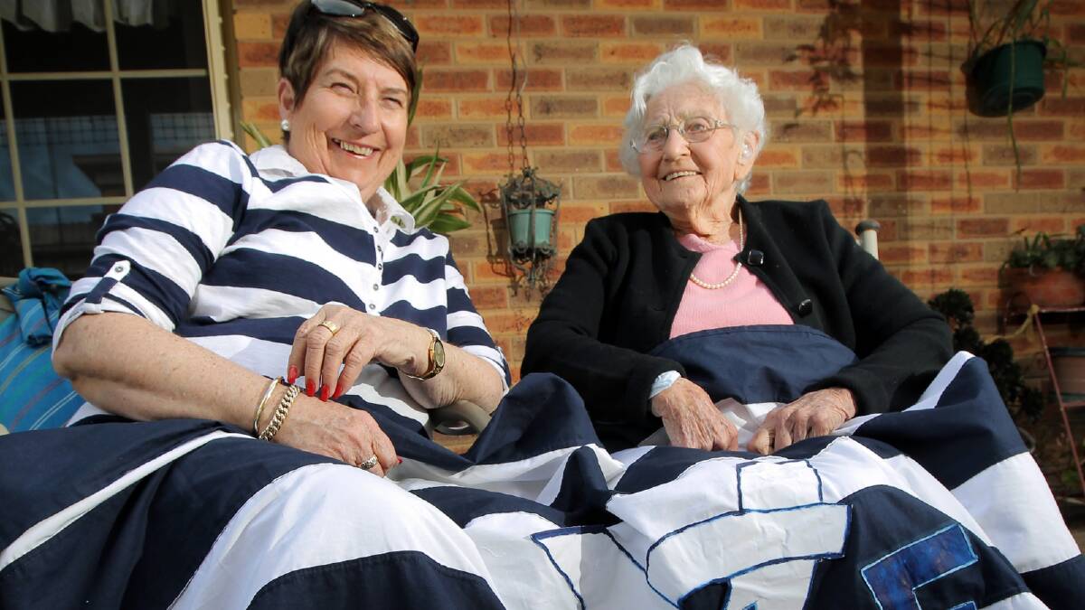 Joy Jeffery and Jean Keenan who turned 100 last week have made a banner to celebrate Yarrawonga making the grand final. Picture: DAVID THORPE